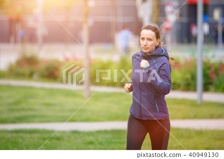 Fitness woman jogging in park in the sunny morning 40949130