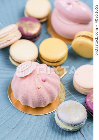 Pink mousse-cake. French macaroon dessert and flowers eucalyptus on a turquoise background. pastel 40951055