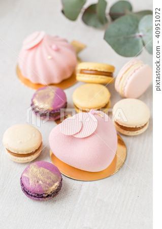 Pink mousse-cake. French macaroon dessert and flowers eucalyptus on a white background. pastel Pink mousse-cake. French macaroon dessert and flowers eucalyptus on a white background. pastel 40951072