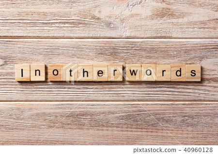 in other words word written on wood block. in other words word written on wood block. 40960128