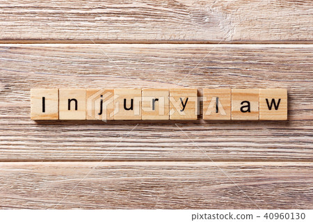 INJURY law word written on wood block. INJURY law word written on wood block. 40960130