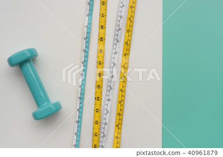 Fitness concept dumbbell and measuring tape  40961879