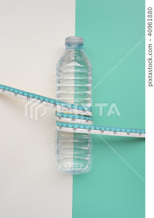 Bottles of water with tape measure for background Bottles of water with tape measure for background 40961880