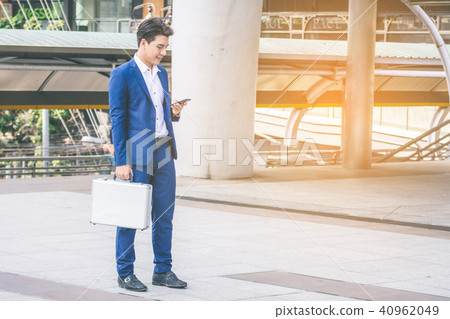 businessman in suit using smartphone at city businessman in suit using smartphone at city 40962049