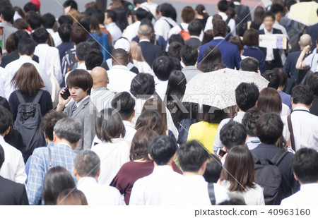A businessman standing at commuting rush hour A businessman standing at commuting rush hour 40963160