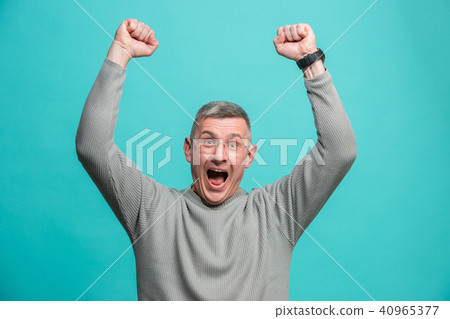 Winning success man happy ecstatic celebrating being a winner. Dynamic energetic image of male model 40965377