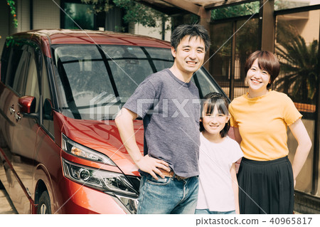 Three families standing side by side in front of car life family Three families standing side by side in front of car life family 40965817