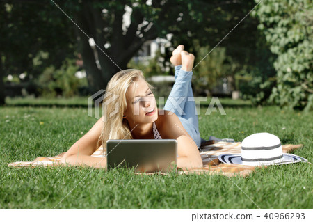 Young woman with laptop in park 40966293