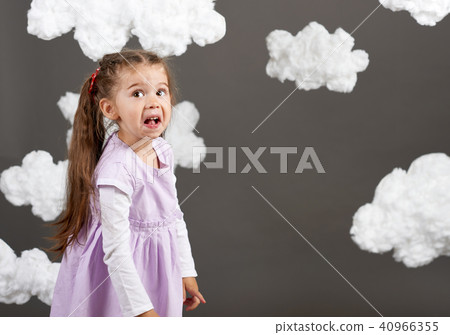 happy girl playing with clouds, gray background happy girl playing with clouds, gray background 40966355
