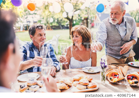 Family celebration or a garden party outside in the backyard. 40967144