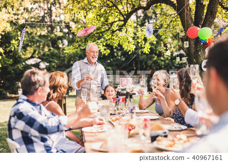 Family celebration or a garden party outside in the backyard. 40967161