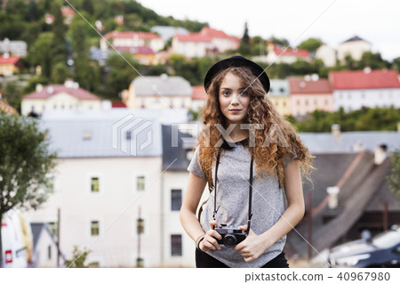 Beautiful young tourist with camera in the old town. Beautiful young tourist with camera in the old town. 40967980