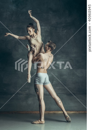 The young modern ballet dancers posing on gray studio background The young modern ballet dancers posing on gray studio background 40968945