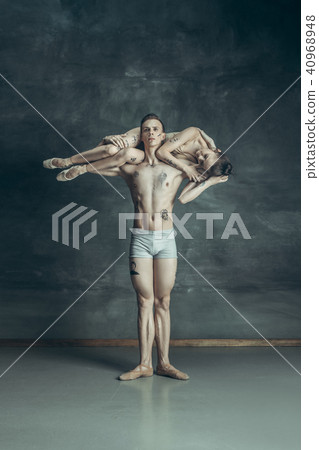 The young modern ballet dancers posing on gray studio background The young modern ballet dancers posing on gray studio background 40968948