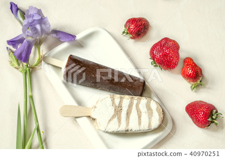 Two kinds of ice cream on a stick with chocolate Two kinds of ice cream on a stick with chocolate 40970251