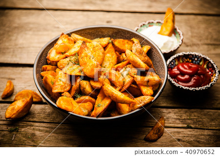 Baked potato fries on wooden table 40970652
