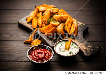 Baked potato fries on wooden table 40970788