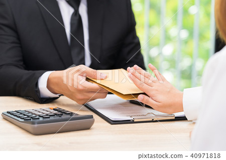 Woman rejecting money in envelope offered Woman rejecting money in envelope offered 40971818