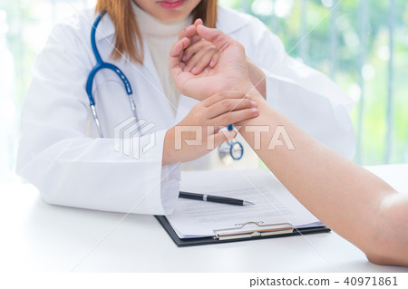 Doctor examining pulse of patient by hands Doctor examining pulse of patient by hands 40971861
