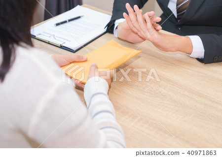 Businessman rejecting money in envelope Businessman rejecting money in envelope 40971863