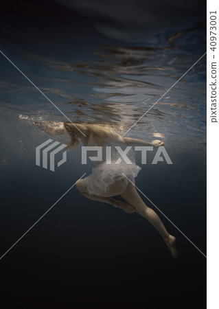 Woman in white dress under water Woman in white dress under water 40973001
