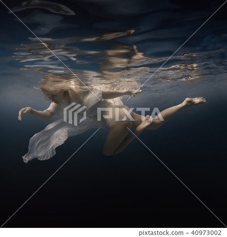 Woman in white dress under water Woman in white dress under water 40973002