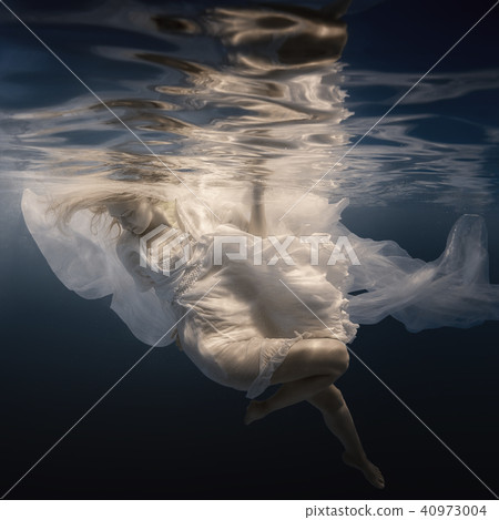 Woman in white dress under water 40973004