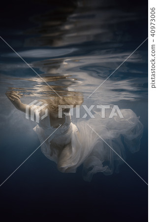 Woman in white dress under water 40973006