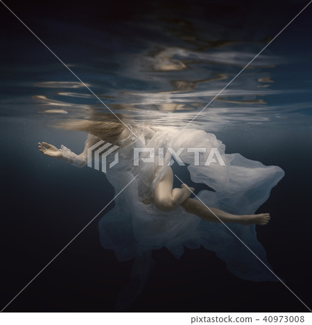 Woman in white dress under water Woman in white dress under water 40973008