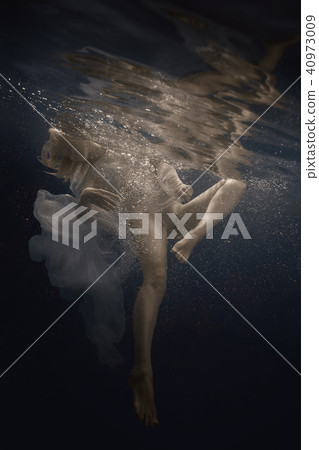 Woman in white dress under water Woman in white dress under water 40973009
