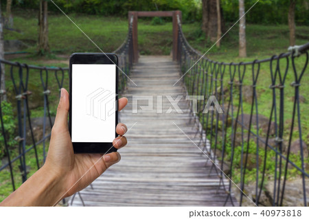Hand holding black smartphone with white screen. Hand holding black smartphone with white screen. 40973818