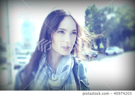 Street portrait of a young woman in wind 40974203