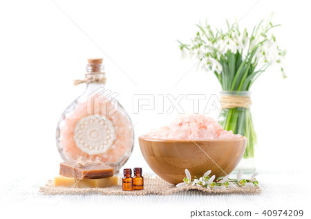 two bottles with organic essential oil with fresh snowdrop flowers, soap, himalayan salt on old 40974209