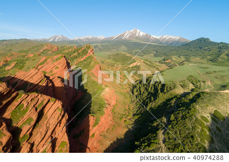 Red Rocks, Coniferous Forest and Mountains on Background. Aerial View Red Rocks, Coniferous Forest and Mountains on Background. Aerial View 40974288
