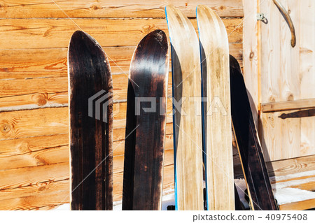 wide hunting skis near door of wooden cottage wide hunting skis near door of wooden cottage 40975408