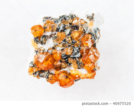 rough crystals of spessartine garnet on white rough crystals of spessartine garnet on white 40975520