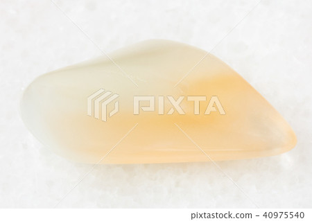 tumbled yellow moonstone (adularia) gem on white 40975540