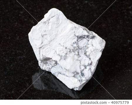 raw Howlite stone on black granite 40975779