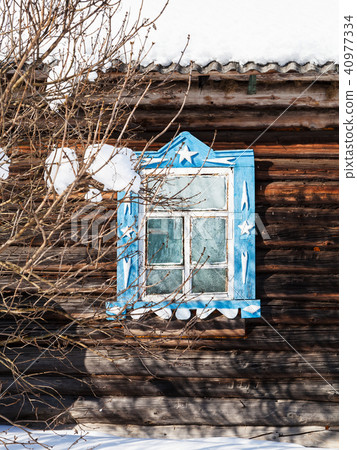 carved window in wooden wall of old rural house 40977334