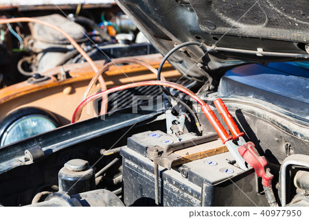 Jump starting old car battery with another vehicle 40977950