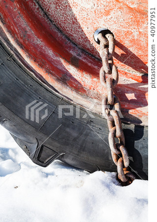 rusty snow chain fitted to tractor wheel rusty snow chain fitted to tractor wheel 40977951