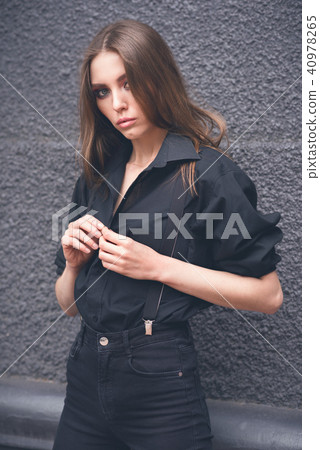 Beautiful girl on a black wall background Beautiful girl on a black wall background 40978265