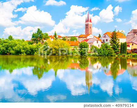 Tower of Church of the Holy Spirit in Telc on sunny summer day reflected in the water, Czech Tower of Church of the Holy Spirit in Telc on sunny summer day reflected in the water, Czech 40979114