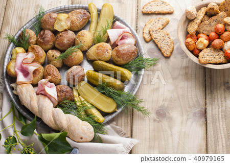 Snacks on a plate for a party . Vintage photo. Wooden background. Copy space 40979165