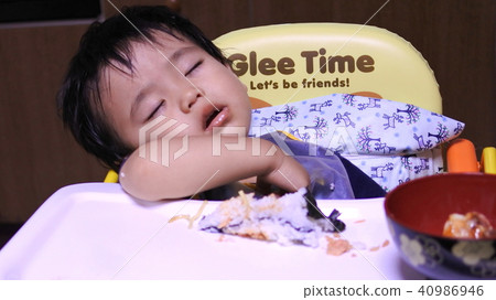 A one-year-old boy who fell asleep during a meal A one-year-old boy who fell asleep during a meal 40986946