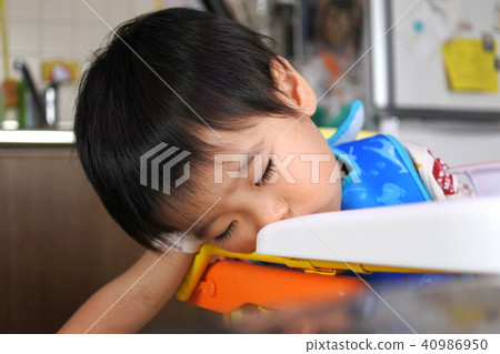 A one-year-old boy who fell asleep during a meal A one-year-old boy who fell asleep during a meal 40986950