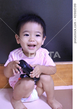 One-year-old boy with disposable diapers 40988599