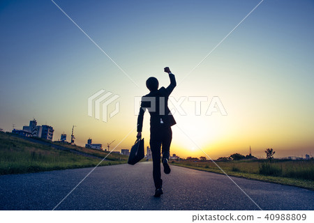 A businessman who jumps to the morning sun 40988809