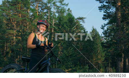 Fat bike also called fatbike or fat-tire bike in summer riding in the forest. 40989230