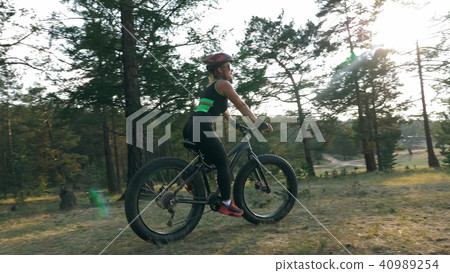 Fat bike also called fatbike or fat-tire bike in summer riding in the forest. 40989254